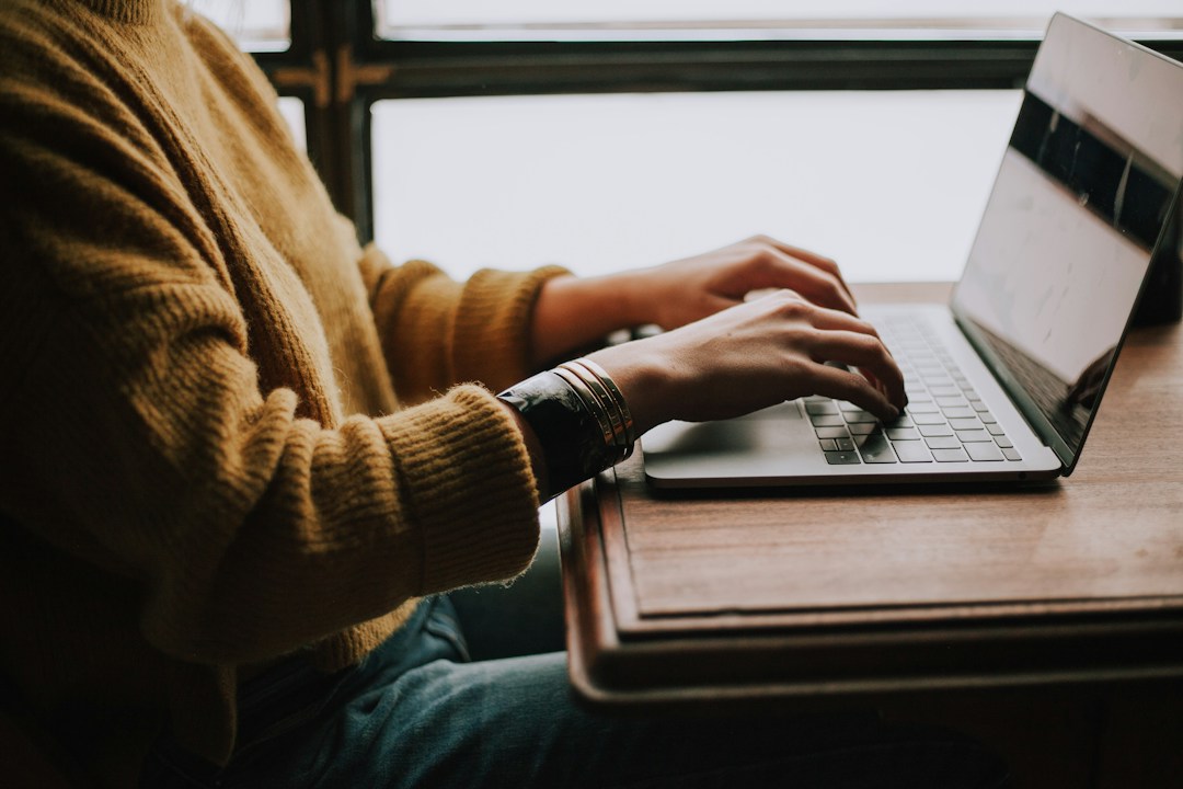 Learner studying with a notebook and laptop, illustrating active recall and AI-supported study