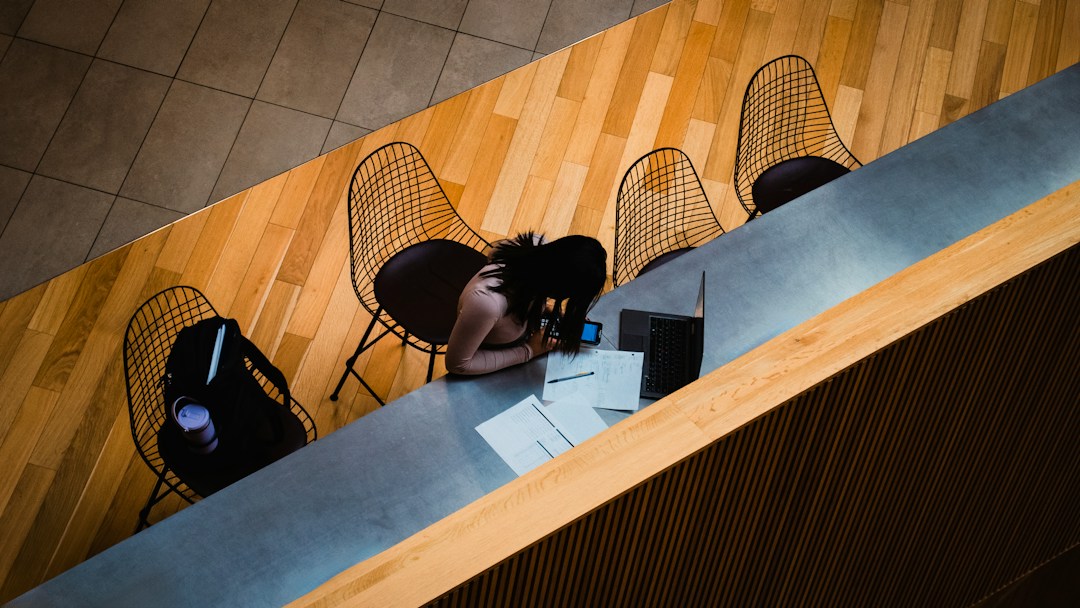 University administrator reviewing digital information on a laptop at a desk