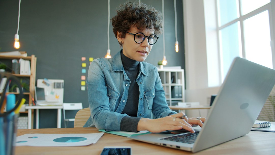 Knowledge worker studying at a laptop in a modern office while developing new technical skills