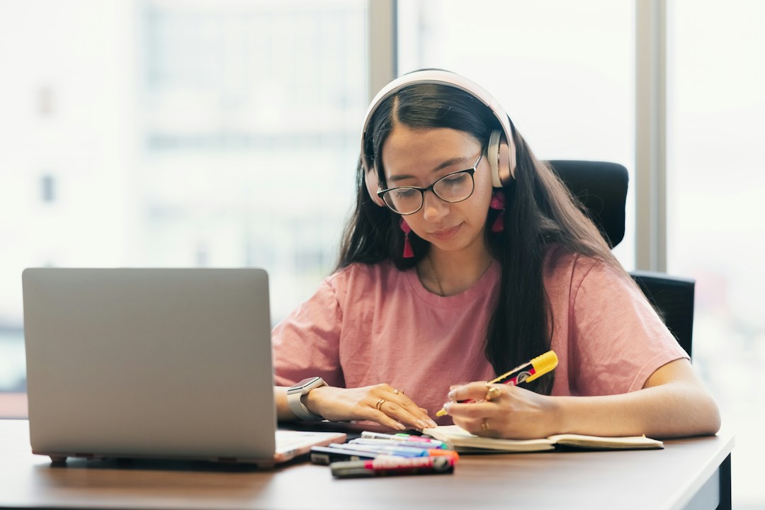 Student studying at a desk with a laptop