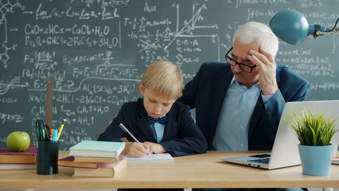 Teacher speaking with a student at a classroom desk during an individual learning check